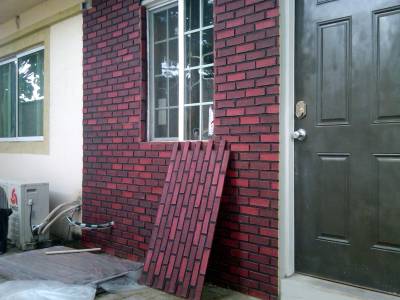 Dark brick interlock veneers installed on a front porch