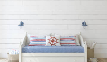 A childhood nautical bedroom with a white accent wall