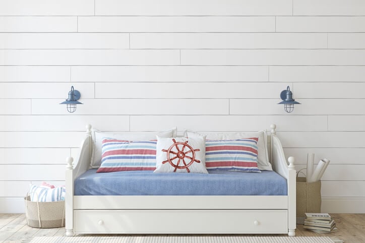 A childhood nautical bedroom with a white accent wall